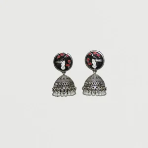 Black bird enamel jhumka earrings with white bird motifs, red florals, and pearl dangles on neutral background
