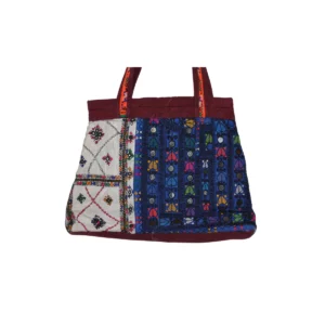 Quilted patchwork tote bag with mixed embroidered fabric panels and burgundy trim