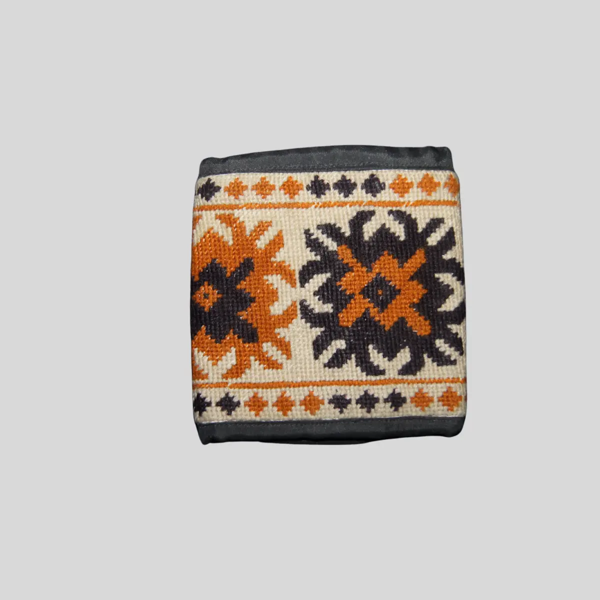 Orange square wallet with hand-embroidered geometric floral pattern in navy and turquoise