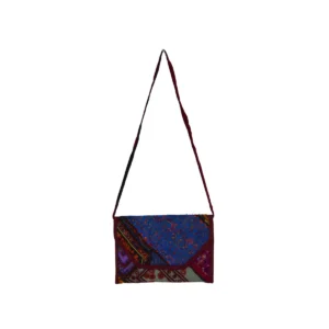 Envelope-style crossbody bag with mixed patchwork fabrics in blue, burgundy, and cream