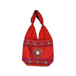Bright scarlet red hobo bag with tribal mirror clusters and bold color saturation