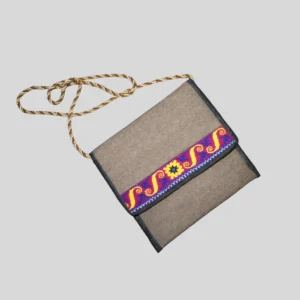 Natural woven shoulder bag with triple-braided handle strap and ethnic stripe pattern