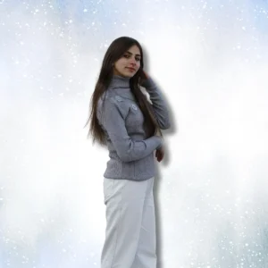 Woman wearing gray ribbed turtleneck sweater and white wide leg pants without jacket